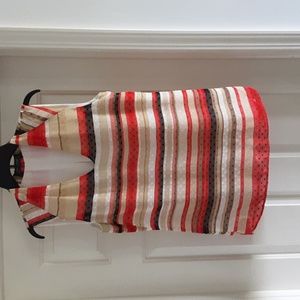 Sleeveless top with back pleat.